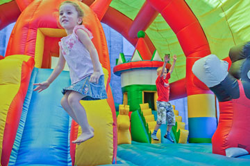 children playing on an inflatable playset